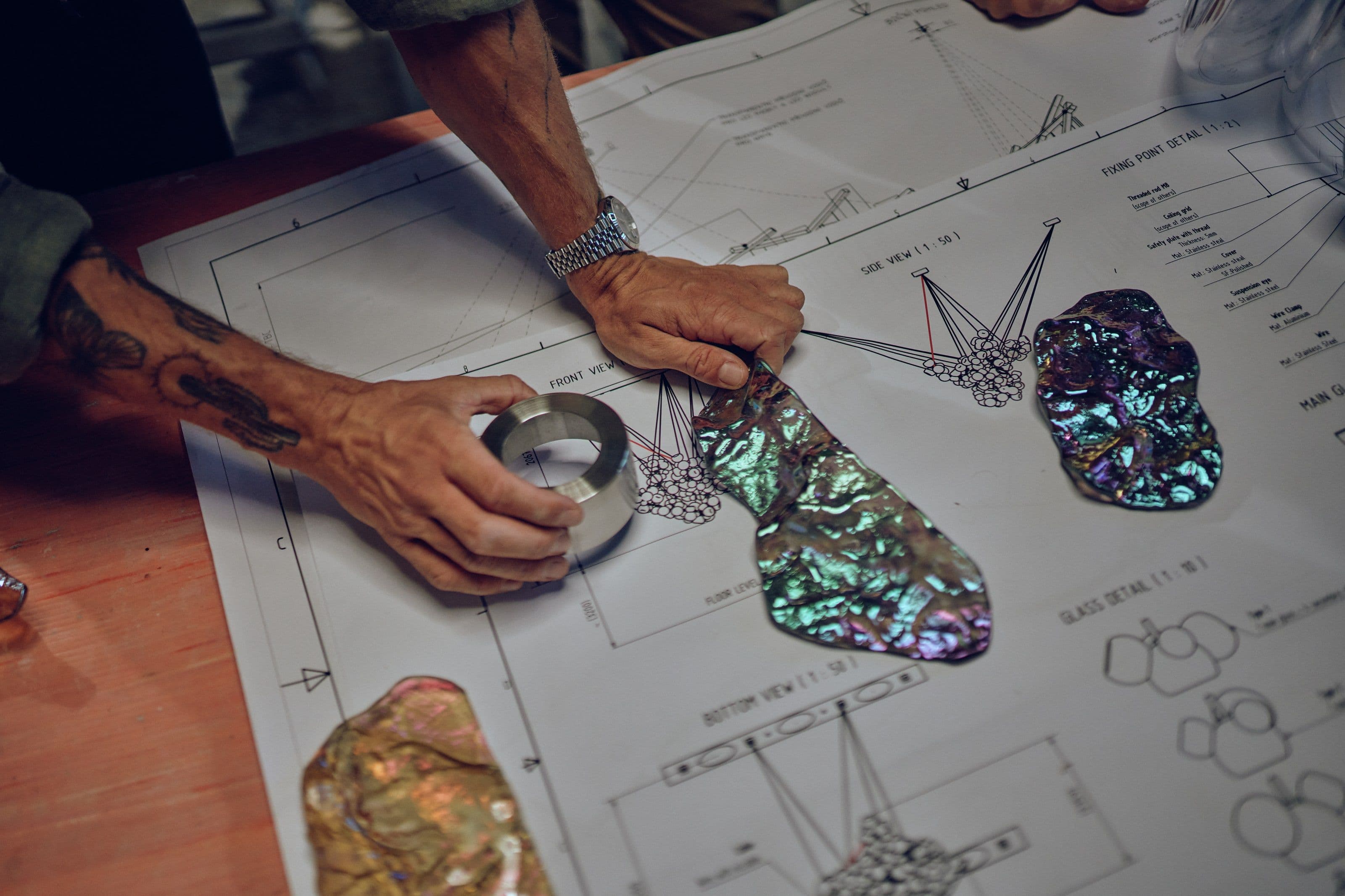 Design process with glass samples and technical drawings