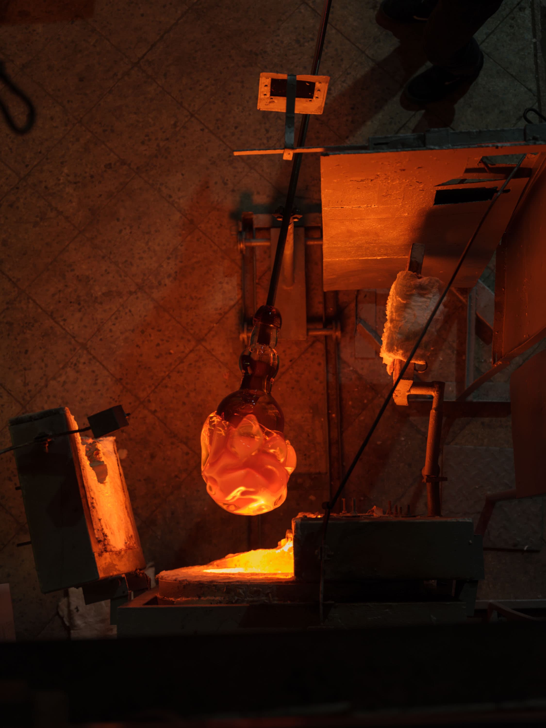 Glassblowing in progress with molten glass